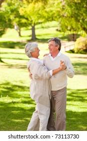 Mature Couple Dancing In The Park