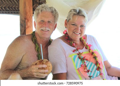 Mature Couple, Enjoy A Coconut In Tahiti.