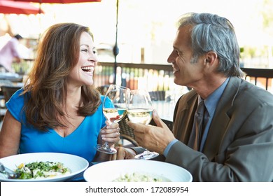 Mature Couple Enjoying Meal At Outdoor Restaurant