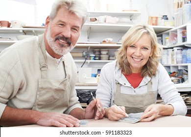 Mature Couple Enjoying Pottery Class Together - Powered by Shutterstock