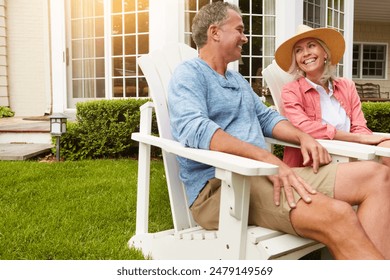 Mature couple, garden and relax in summer on chair with funny memory, bonding and conversation with love at house. Man, woman and talking with laugh, comic story and chat on grass in home backyard - Powered by Shutterstock