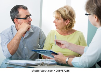Mature couple getting financial advice from consultant at home