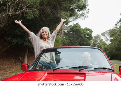 Mature Couple Having A Ride Together In Red Convertible