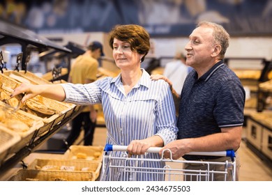 Mature couple husband and wife choose bakery - Powered by Shutterstock