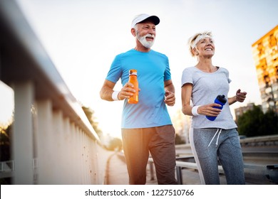 Mature couple jogging   running outdoors in city