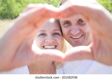 Mature Couple In Love Showing Heart Hands