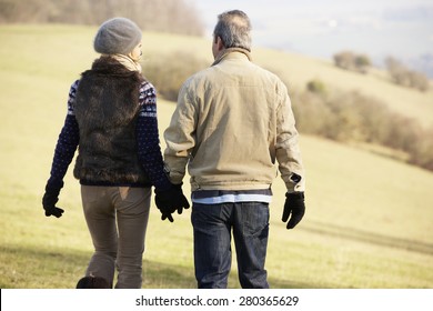 Mature Couple On Country Walk In Winter