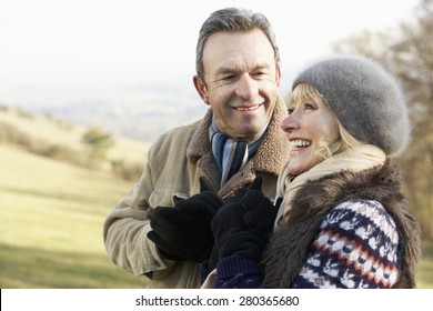 Mature Couple On Country Walk In Winter