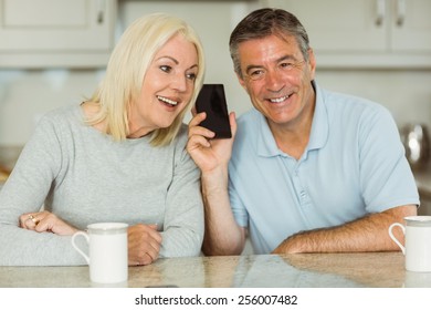 Mature Couple On A Phone Call Together At Home In The Kitchen