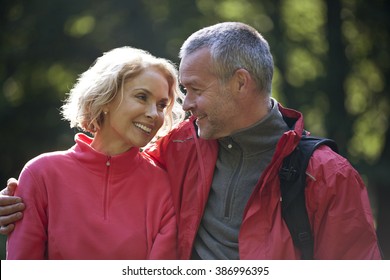 A mature couple outdoors, looking affectionately at each other