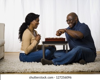 Mature Couple Playing A Board Game