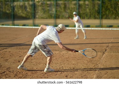 Mature Couple Playing Tennis