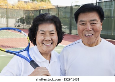 Mature Couple Playing Tennis, Portrait