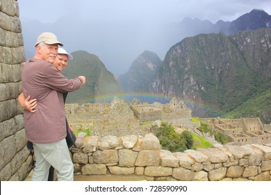 Mature Couple, Pointing Out A Rainbow In Machu Picchu.