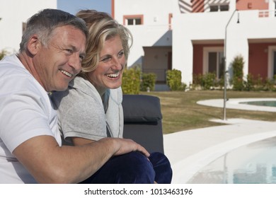 Mature Couple Relaxing By Pool