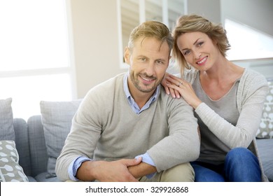 Mature Couple Relaxing In Couch At Home