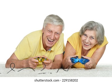 Mature Couple Relaxing At Home On A White Background