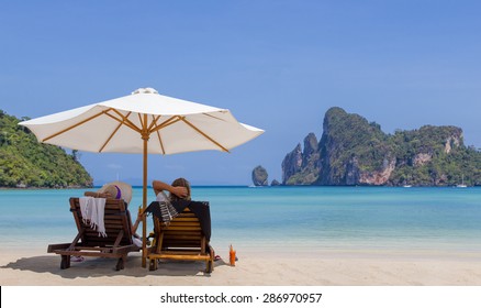 Mature Couple Relaxing On The Beach In Thailand