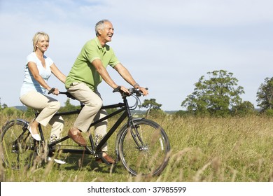 Mature Couple Riding Tandem