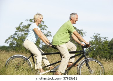 Mature Couple Riding Tandem