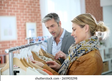 Mature Couple Shopping In Clothing Store