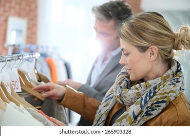 Mature Couple Shopping In Clothing Store