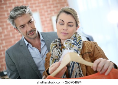 Mature Couple Shopping In Clothing Store