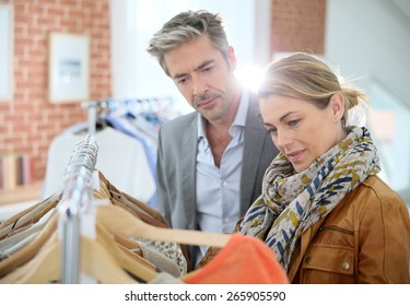 Mature Couple Shopping In Clothing Store