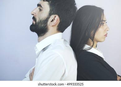 Mature Couple Standing Back To Back