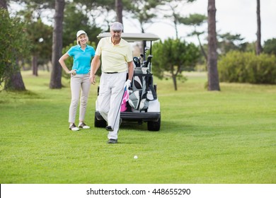 Mature Couple Standing At Golf Course