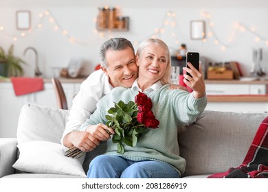 Mature Couple Taking Selfie While Celebrating Valentine's Day At Home