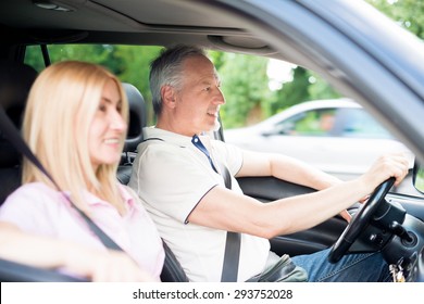 Mature Couple Traveling In Their Car