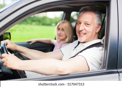 Mature Couple Traveling In Their Car