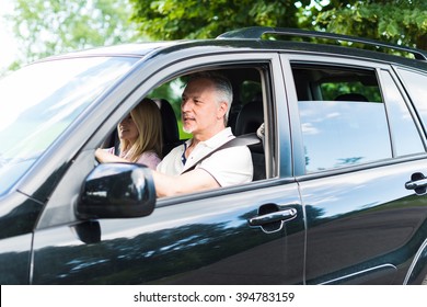 Mature Couple Traveling In Their Car