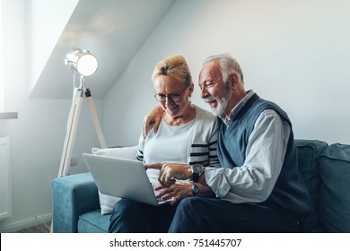 Mature Couple Using Laptop At Home.