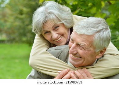 Mature Couple Walking In The Autumn Park