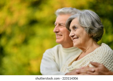 Mature Couple Walking In The Autumn Park