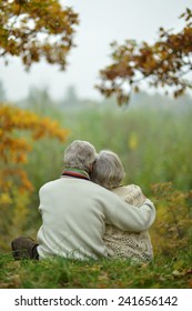 Mature Couple Walking In The Autumn Park