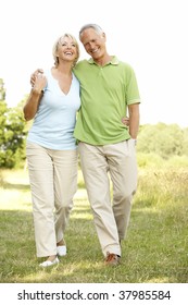 Mature Couple Walking In Countryside