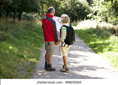 A mature couple walking in the countryside, holding a map - Powered by Shutterstock