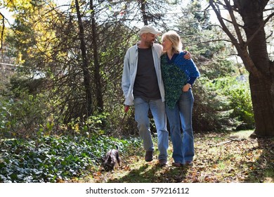 Mature Couple Walking Dog