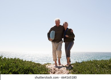 Mature Couple Walking Over Dune