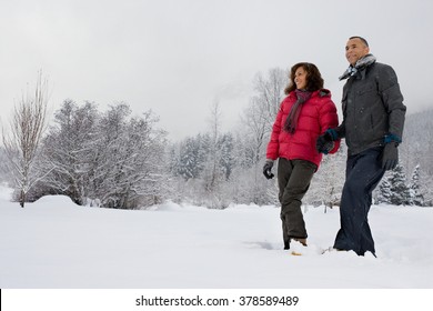 Mature Couple Walking Through Snow