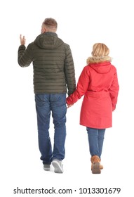 Mature Couple In Warm Clothes Walking On White Background