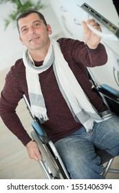 Mature Disabled Man Opening The Door Of The Oven