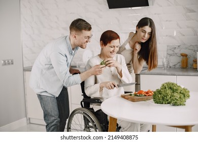 Mature Disabled Woman Cutting Vegetables In The Kitchen