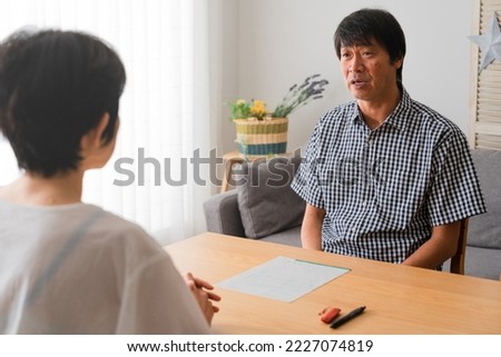 Mature divorce image of a middle man and middle woman couple who argue.