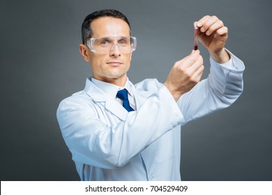 Mature Doctor Holding Test Tube With Blood Sample