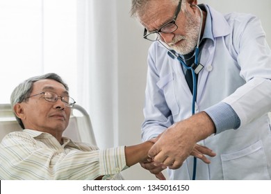 Mature doctor talking and examining health of senior patient in hospital ward. Medical healthcare and doctor staff service concept. - Shutterstock ID 1345016150