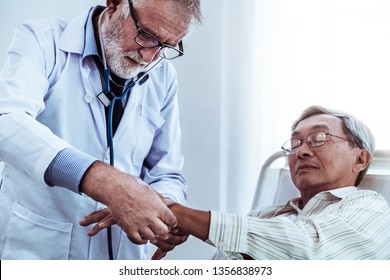 Mature doctor talking and examining health of senior patient in hospital ward. Medical healthcare and doctor staff service concept. - Shutterstock ID 1356838973